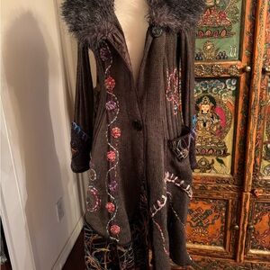 A beautiful multi colored sweater jacket.  Fur color and embroidered details